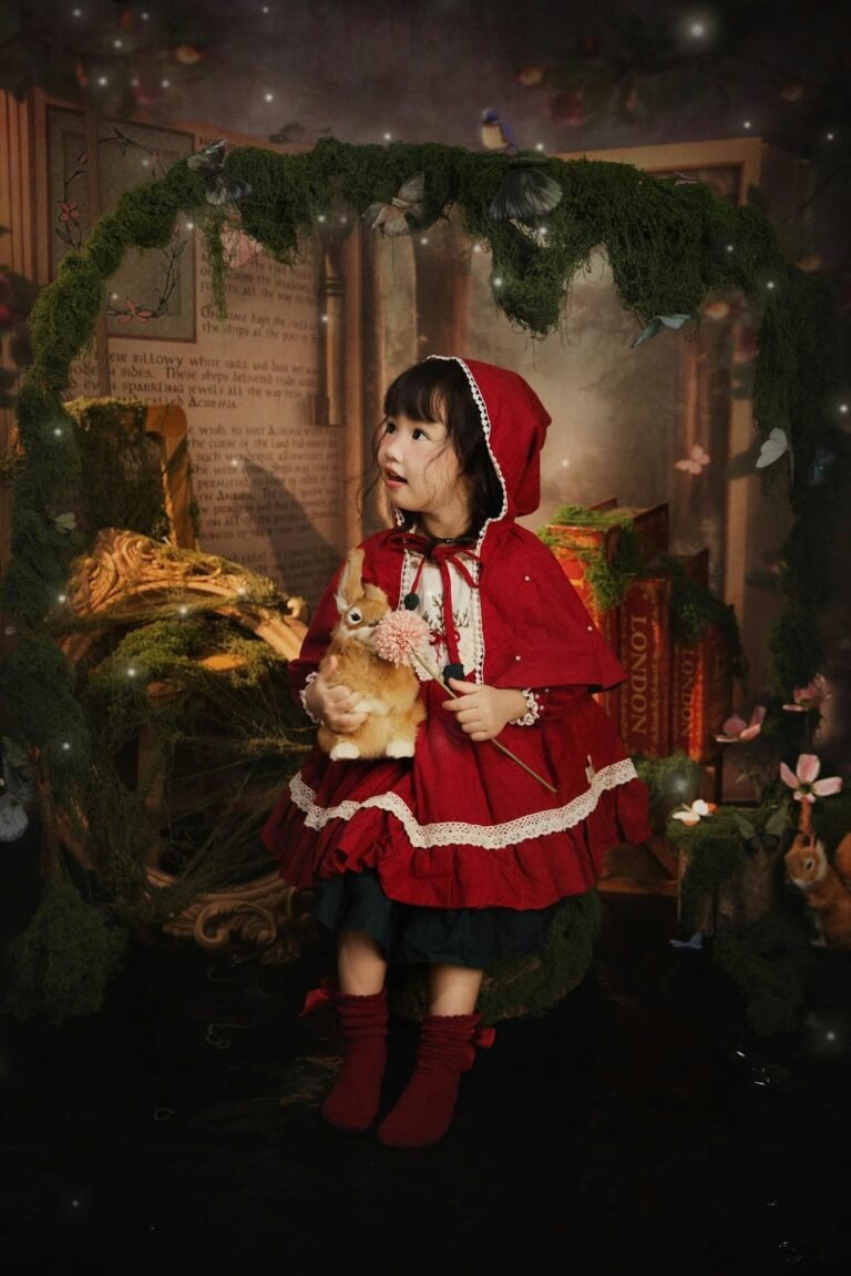 Child in red cape with rabbit in magical forest setting, fairy tale theme.